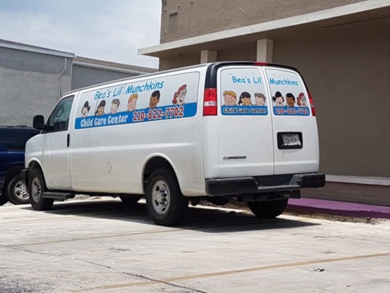 Large passenger van with side and rear Window Decals.