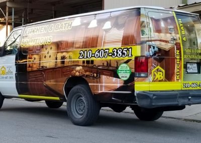 Picture (driver side and rear) of a partial Van Wrap in printed vinyl for a San Antonio TX based remodeling contractor.