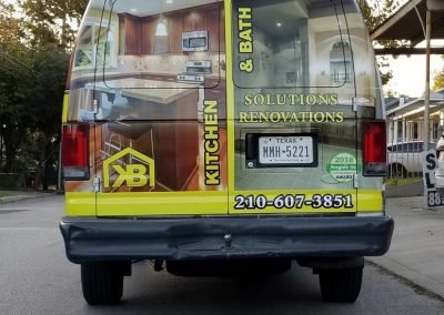 Van Wrap. Picture of the rear of a van wrapped in vinyl printed with image of bathroom and kitchen for a renovation company.