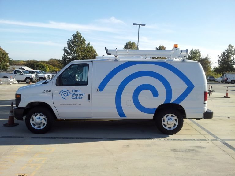 Commercial van's driver side with Time Warner Vinyl Graphics.